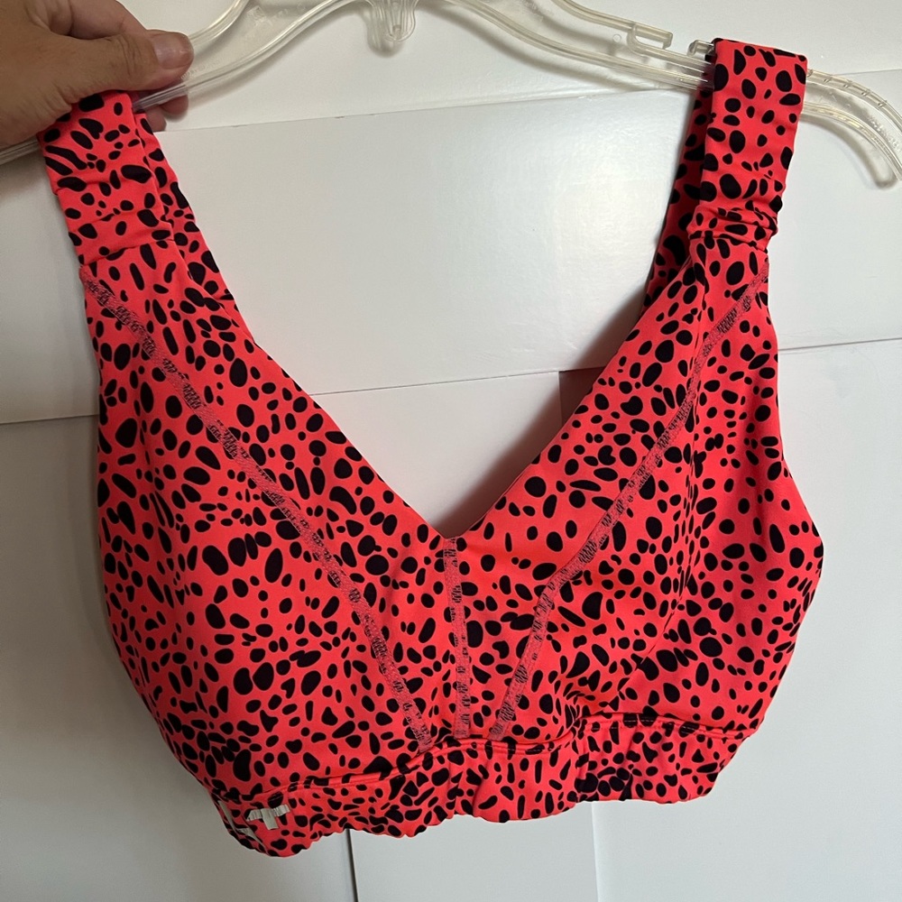 Glider, hot pink/coral cheetah print sports bra, AKT logo, size medium.